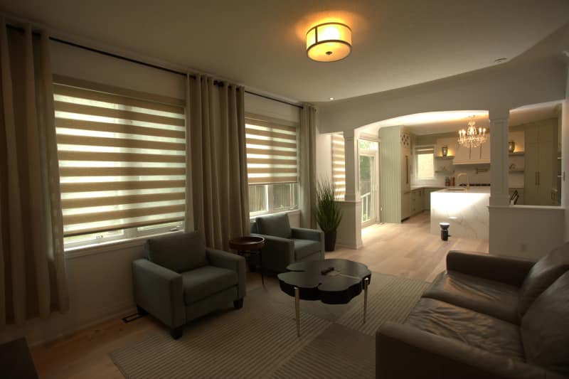 Living room before editing, shot as a single exposure, with bright windows and dark interior